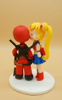 Picture of Sailor Moon and DeadPool wedding cake topper