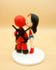 Picture of Wonder Woman and Dead Pool Wedding Cake Topper