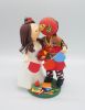 Picture of San Francisco 49ers fan groom & school teacher bride wedding cake topper