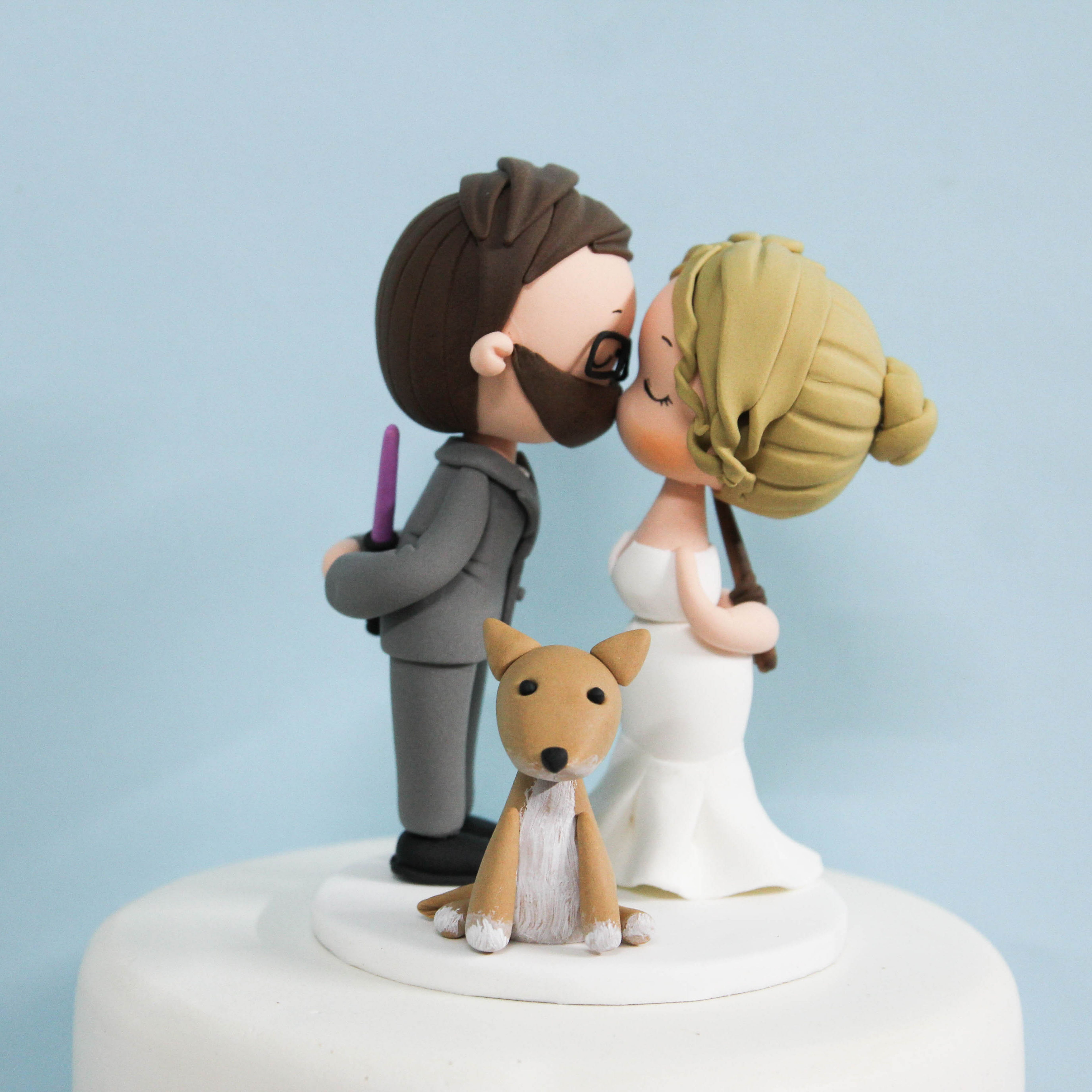 Picture of Harry Potter & Star Wars wedding cake topper, bride & groom with dog cake topper