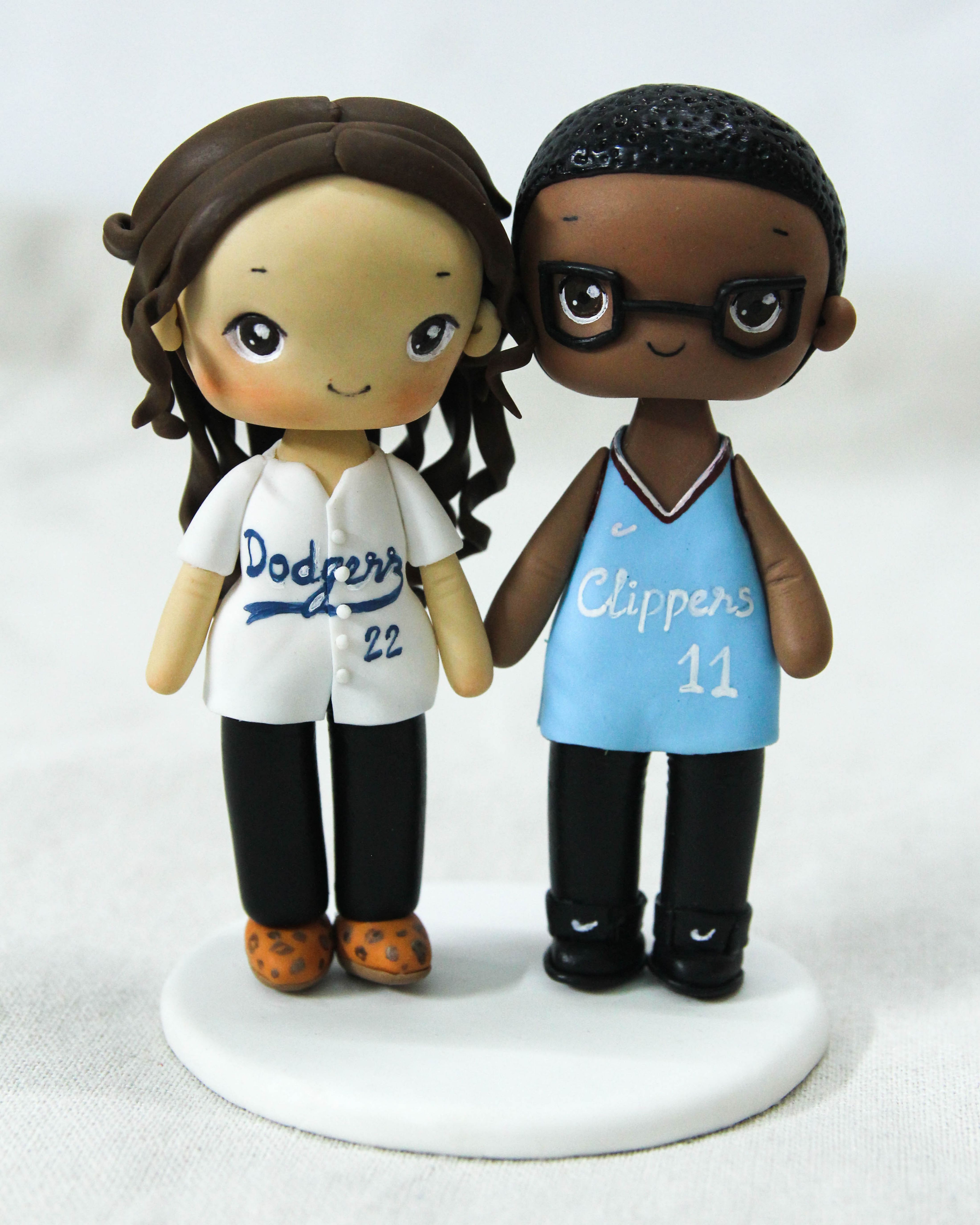 Picture of Dodgers and Clippers fan wedding cake topper, baseball bride & basketball groom cake topper